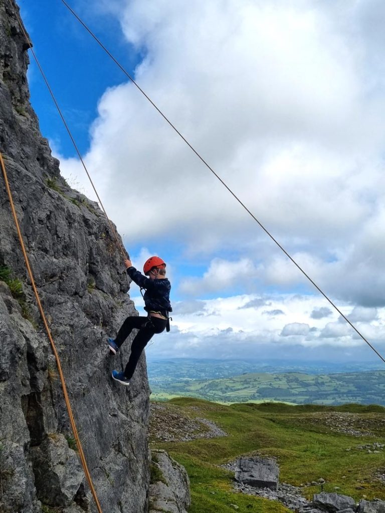 boy rock climbing